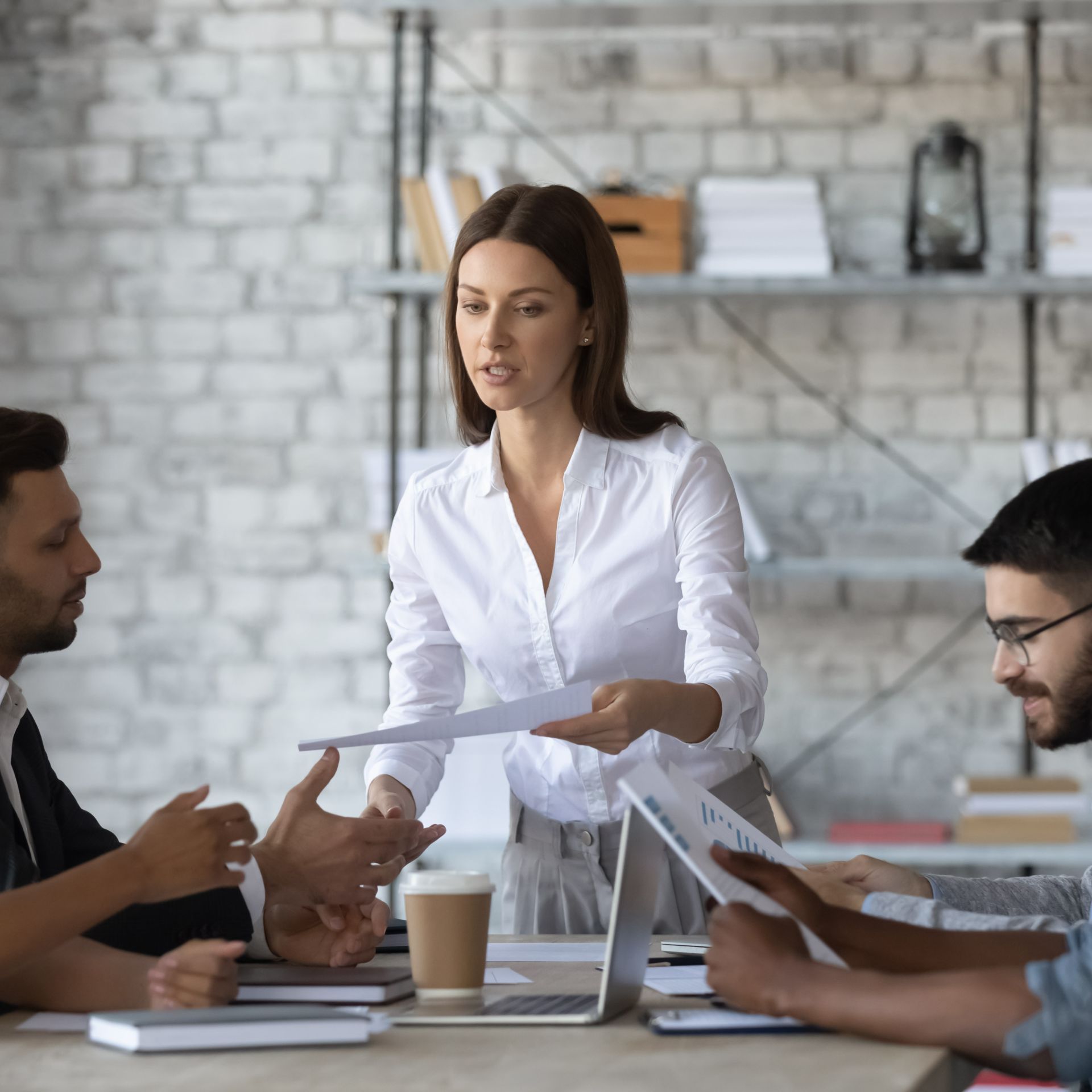 A woman leading a business meeting with attentive colleagues.