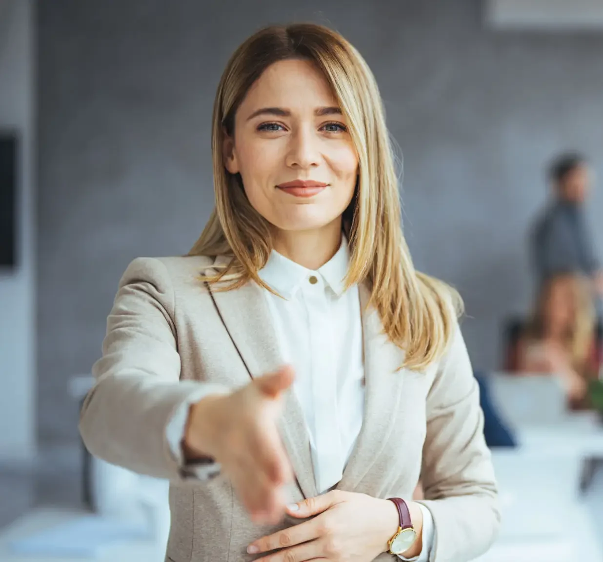 Professional woman extending her hand for a handshake.