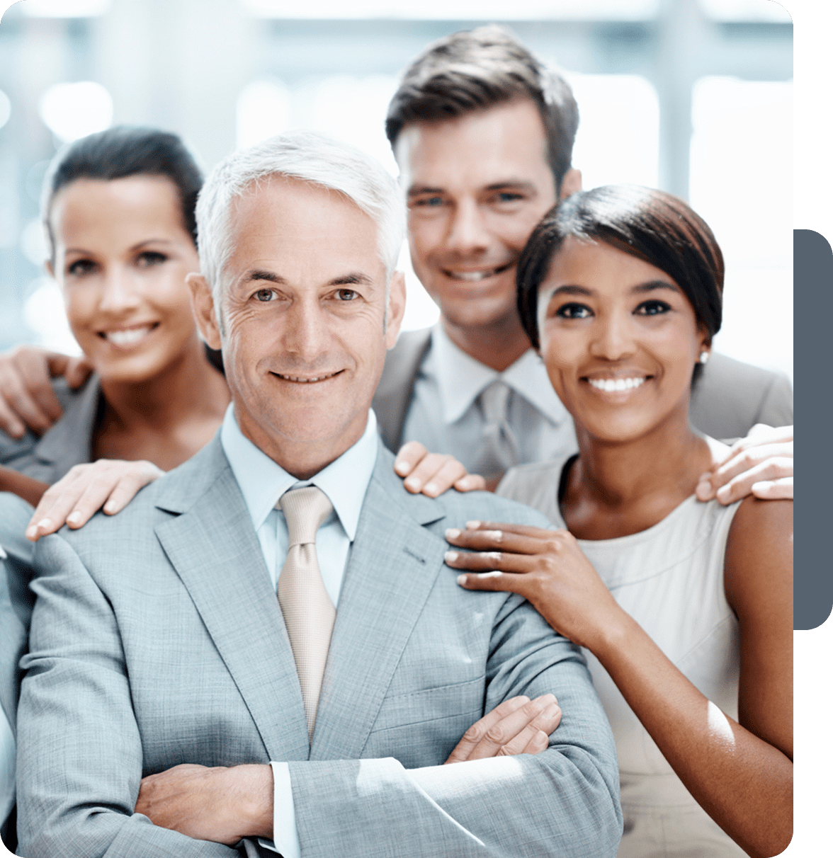 Confident business team smiling together in an office setting.