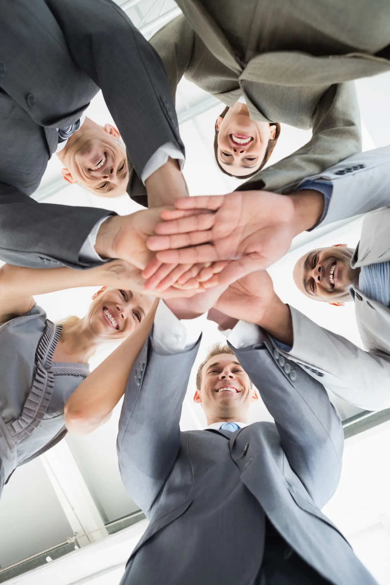 Business team joining hands in a unity gesture.